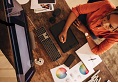 Freelancer working at her creative workstation. High angle view of a female graphic designer drawing on a digital tablet. Creative young woman working on a new design in her home office.